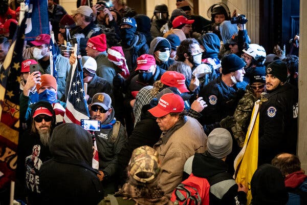 Pro-Trump rioters stormed the Capitol on Jan. 6, 2021. One active-duty service member and about 40 former members of the military have been charged in connection with the attack.