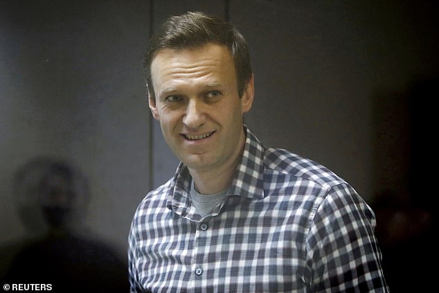Putin also said that the opposition leader's continued detention was not his decision, and noted the poor state of medical care inside Russia's jails. Pictured: Russian opposition politician Alexei Navalny attends a court hearing in Moscow, Russia February 20, 2021