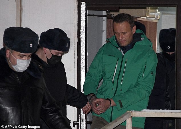 On January 17, 2021, the opposition leader returned to Russia and was detained over parole violation accusations, and on February 2 his suspended sentence was replaced with a prison sentence. Pictured: Navalny is escorted out of a police station on January 18, 2021