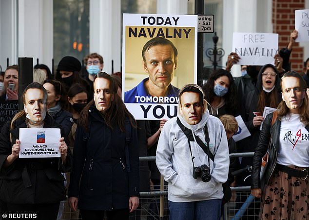 Putin also said Navalny - whose detention has been condemned by Western politicians and activists and sparked protests across Russia - would not be treated any differently from other prisoners. Pictured: Pro-Navalny rrotesters gather outside the Russian Embassy in London