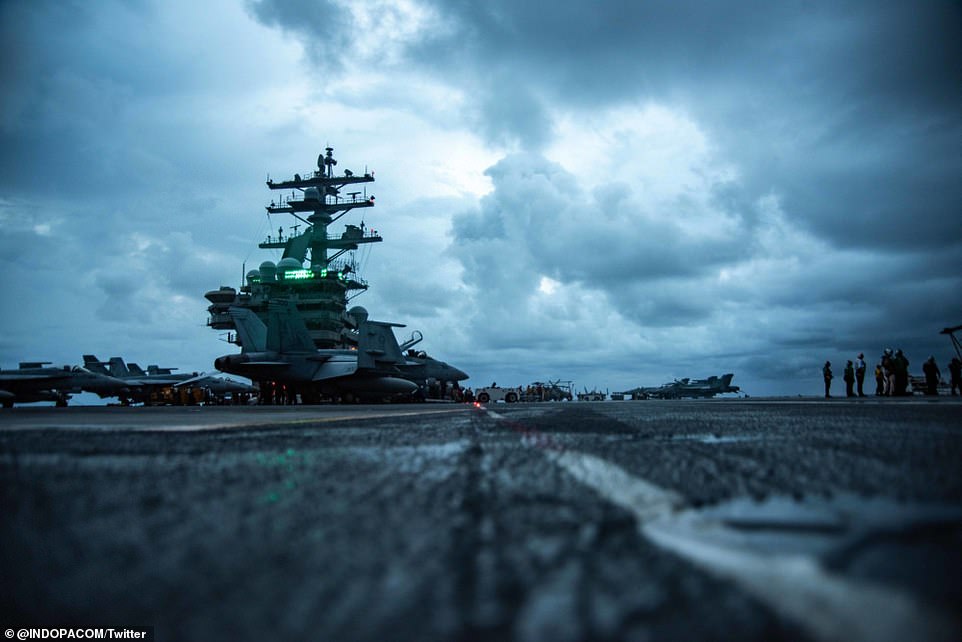 Sailors conduct flight operations on the flight deck of aircraft carrier USS Ronald Reagan on Tuesday