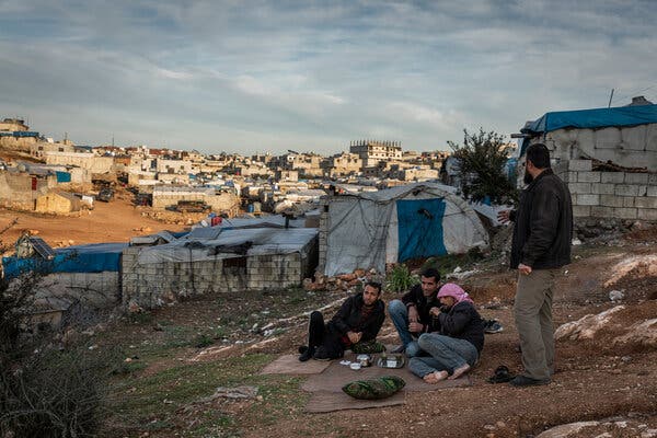 Displaced Syrian men at a refugee camp in Idlib last year.