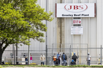 Employees exit from the JBS Beef Production Facility in Greeley, Colorado.