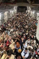 Afghan citizens are evacuated by the US Air Force from Hamid Karzai International Airport in Kabul.